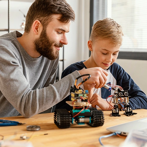 Parent and child working on robotics together